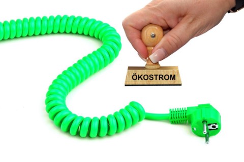 Symbolic image, stamp with the inscription: electricity costs, a green power cable, studio