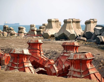 Large concrete tetrapods are placed on the sea shore