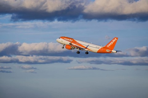 Lisbon, Portugal - Apr 29, 2024: EasyJet Airbus 320 aircraft shot mid-flight, ascending into clear