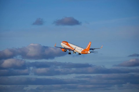 Lisbon, Portugal - Apr 29, 2024: EasyJet Airbus 321 neo aircraft shot mid-flight, ascending into