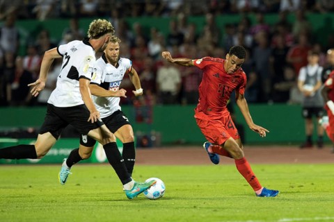 Football match, Jamal MUSIALA FC Bayern Munich right is stopped by Philipp STROMPF SSV Ulm, in the