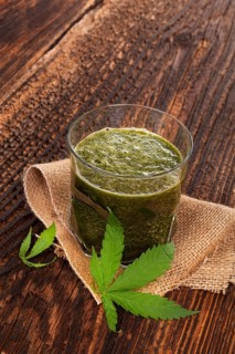 Healthy cannabis smoothie on wooden background. Natural supplement, detox and healthy living