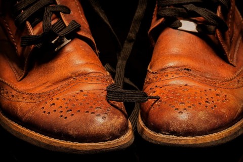 A pair of brown vintage leather shoes on a dark background. Beautiful leather shoes