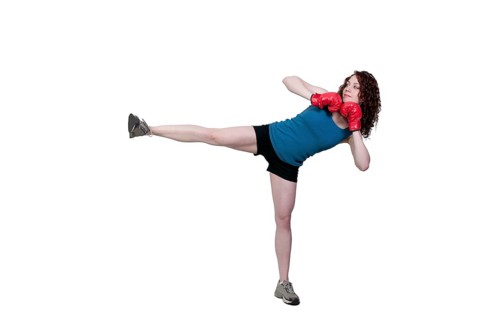 A beautiful young woman practicing martial arts kickboxing