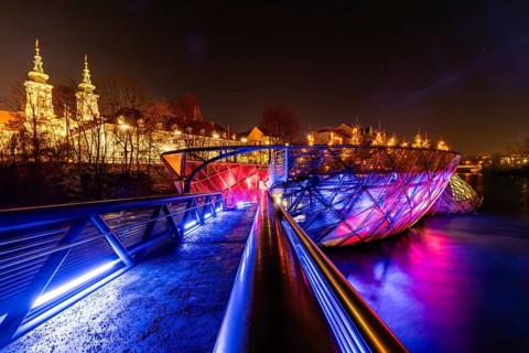 Illuminated Murinsel, Mariahilferkirche in the background, night shot, Graz, Styria, Austria,