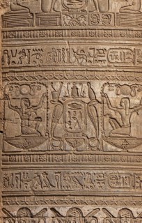 Hieroglyphic carvings on the exterior walls of an ancient egyptian temple