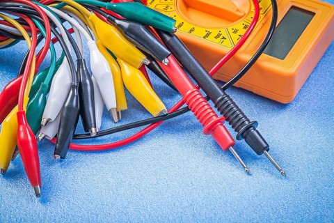 Set of crocodile plugs digital multimeter on blue background