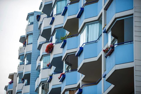 Façade with balconies of an apartment block, also known as a prefabricated building, in the former