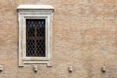 The window with iron gratings on brick wall, for background