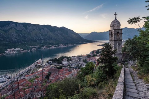 The tower of Church of Our Lady of Remedy and Bay of Kotor view from the hill above the town,