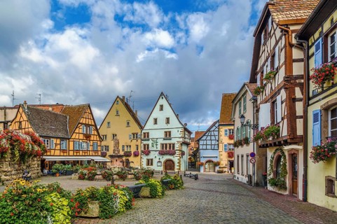 Main square with fountain with statue of pope Leo IX in Eguisheim, Alsace, France, Europe