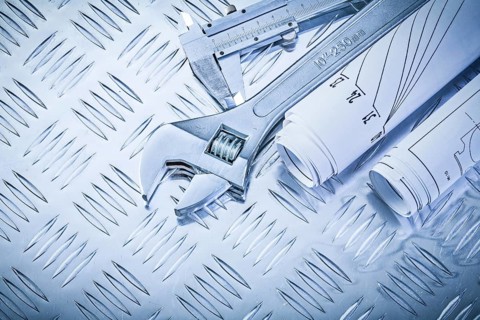 Construction drawings trammel caliper adjustable spanner on grooved metal plate maintenance concept