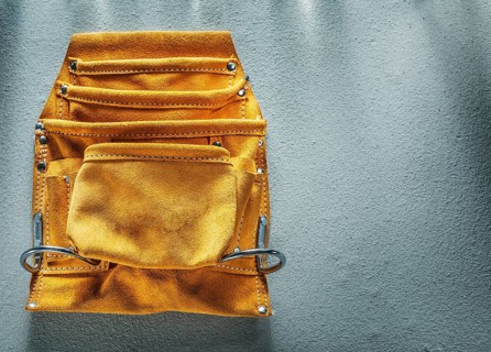 Leather tool belt on concrete background