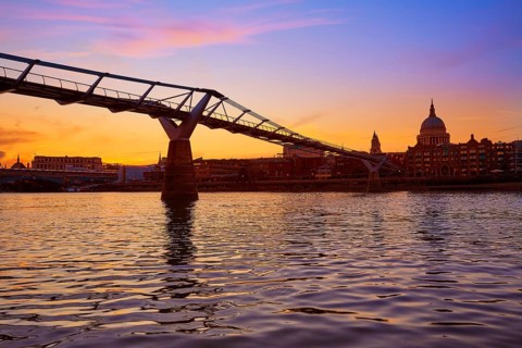 London Millennium bridge sunset skyline in UK at dusk