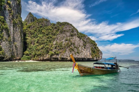 Tropical islands view with long tail boat ocean blue sea water at Pileh Lagoon of Phi Phi Islands,