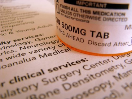 Some prescription medicine on top of some medical documentation