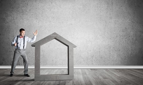 Stone home silhouette in empty room as symbol for real estate insurance