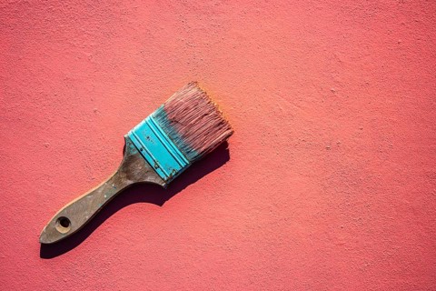 Coral color grunge brush with paint in monochromatic coral background wall