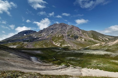 Summer mountain landscape of Kamchatka Peninsula: beautiful view of cone Khangar Volcano on sunny