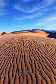 Mesquite Flat Sand Dunes. Bright solar morning in picturesque part of Death Valley. Thin waves on