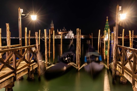 Venetian gondolas, boat dock at St Mark's Square, church of San Giorgio Maggiore in the background,