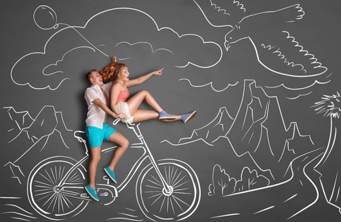Happy Valentine's Day love story concept of a romantic couple on chalk drawings background of