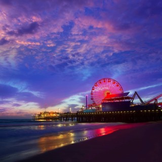 Santa Monica California sunset on Pier Ferrys wheel and reflection on beach wet sand