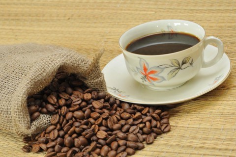 Coffee beans next to a coffee cup. Freshly ground coffee, Coffee beans next a coffee cup. Freshly