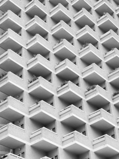 High rise building with residential flats or apartments in a white concrete development with