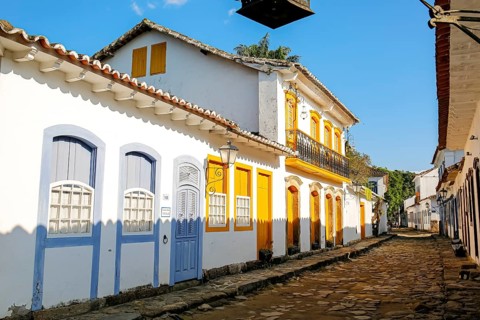 Typical colonial two and one story houses with colorful doors and windows on sunny day in historic
