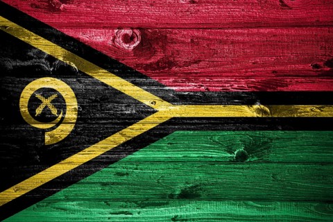 Vanuatu flag on wooden planks background wood flag