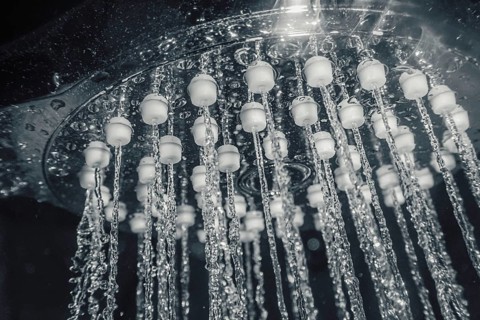 Shower head with flow of water closeup