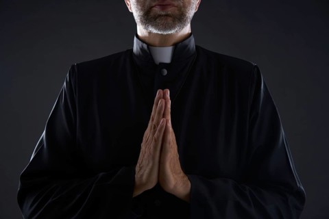 Praying hands priest portrait of male pastor