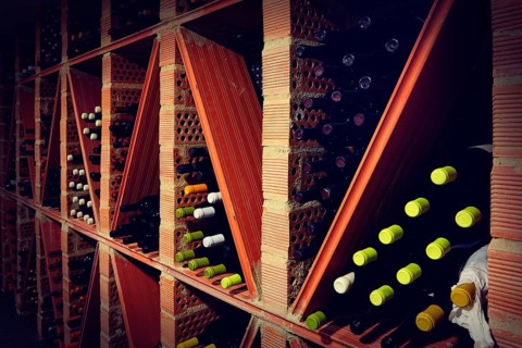 Wine Cellar from Mediterranean with bottles stacked in rows