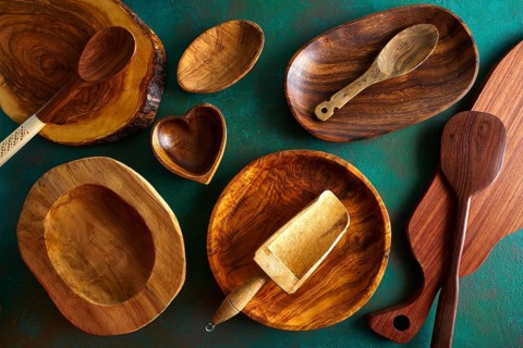 Wooden tableware on grungy green background