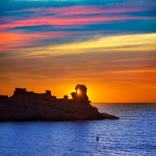 Menorca sunset in Cala Morell at Ses torretes beach Balearic Islands