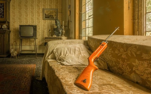 A nostalgic bedroom with a retro TV and a rifle on the sofa, Maison Limmi, Lost Place, Kalken,