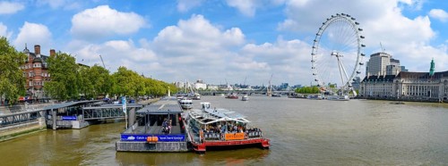 Panorama of Westminster Millennium Pier on the north bank of the River Thames with London Eye at