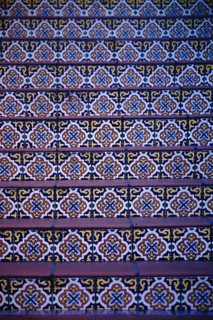 The steps of a staircase decorated with colourful oriental patterned tiles