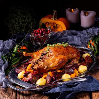 Roast duck with potato dumplings and plums