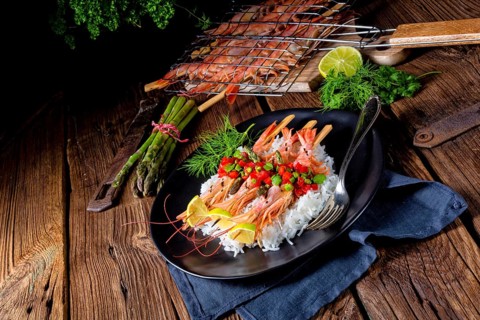Grilled red argentine shrimps with red salsa and green asparagus