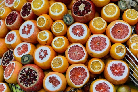 Sliced fruits such as oranges, pomegranates and kiwis show their colourful inner structure,