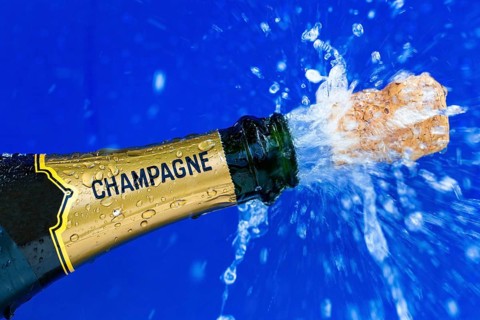 Champagne bottle is opened. Cork shoots out of champagne bottle. Symbolic photo for the turn of the