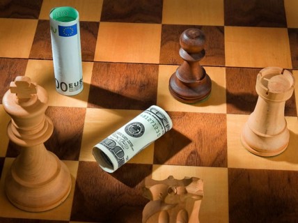 Chess with dollar and euro banknote. Symbol for devaluation of the dollar against the euro. Austria