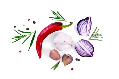 Pod of red hot pepper, slices of purple onion with sprigs of rosemary, garlic and peas of colored