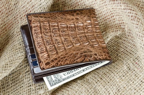 Wallet made ??of genuine crocodile leather over the linen background