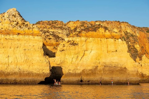 Stand-up paddler at Ponta de Piedade, Lagos, Algarve, Portugal, Europe