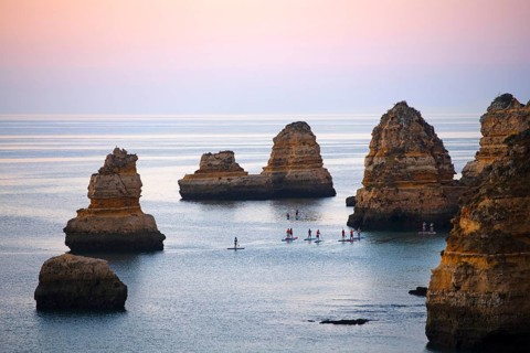 SUP paddlers at Praia Dona Ana, Lagos, Algarve, Portugal, Europe