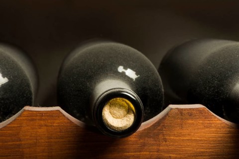 Wine bottles on shelf. Wine cellar. Close up wine bottles