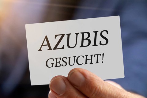 Trainee wanted: Close-up of a man with a business card AZUBI GESUCHT (symbolic image, composing)